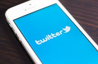 Image of Twitter on phone via Twin Design/Shutterstock