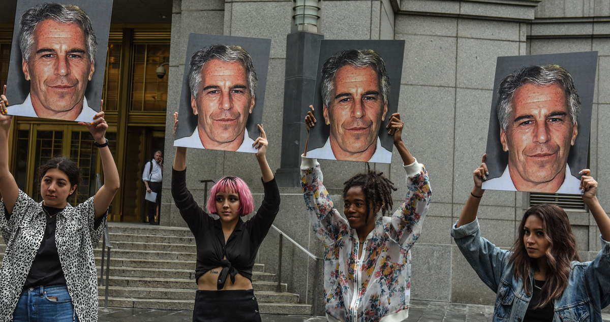 A protest group called "Hot Mess" hold up signs of Jeffrey Epstein in front of the Federal courthouse on July 8, 2019 in New York City. According to reports, Epstein will be charged with one count of sex trafficking of minors and one count of conspiracy to engage in sex trafficking of minors.