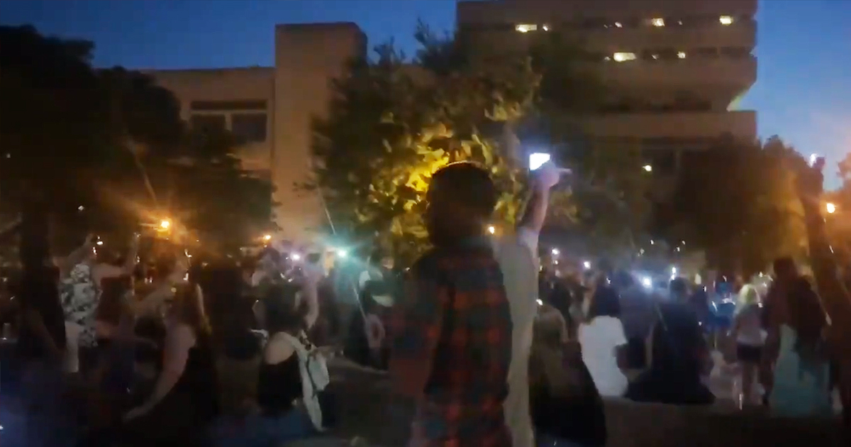 Citizens gathered in Jefferson Square Park in Louisville to remember Breonna Taylor raise their cell phones as they sing along to We Are The World.