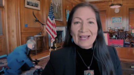 deb haaland staffer crawling behind her