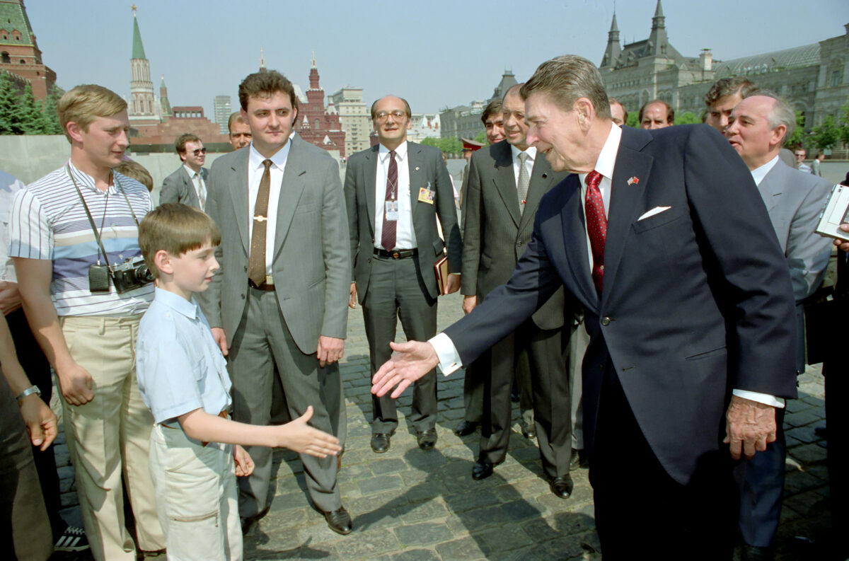Ronald Reagan shakes hand with young boy in Red Square, Moscow