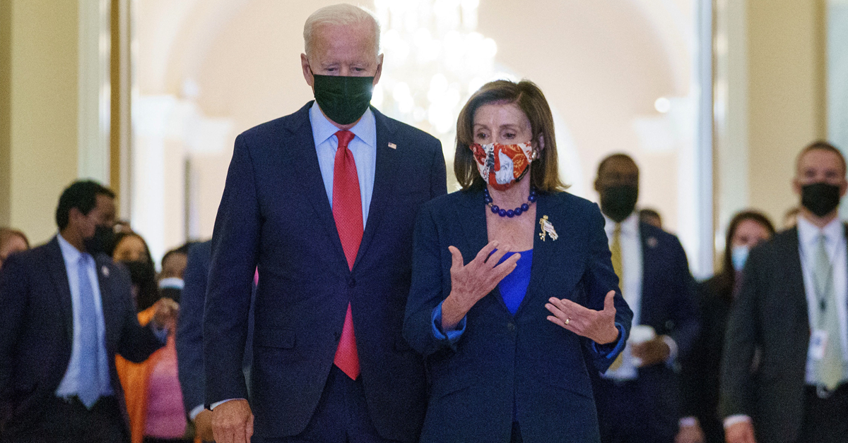 US President Joe Biden walks with Speaker of the House Nancy Pelosi as he departs the US Capitol after a caucus meeting in Washington, DC,