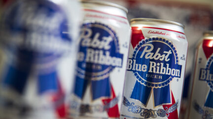 Cans of Pabst Blue Ribbon beer sit on a table