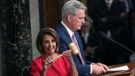 nancy pelosi smiling with gavel and kevin McCarthy in the background january 2019
