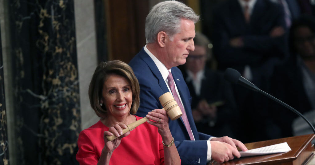 nancy pelosi smiling with gavel and kevin McCarthy in the background january 2019