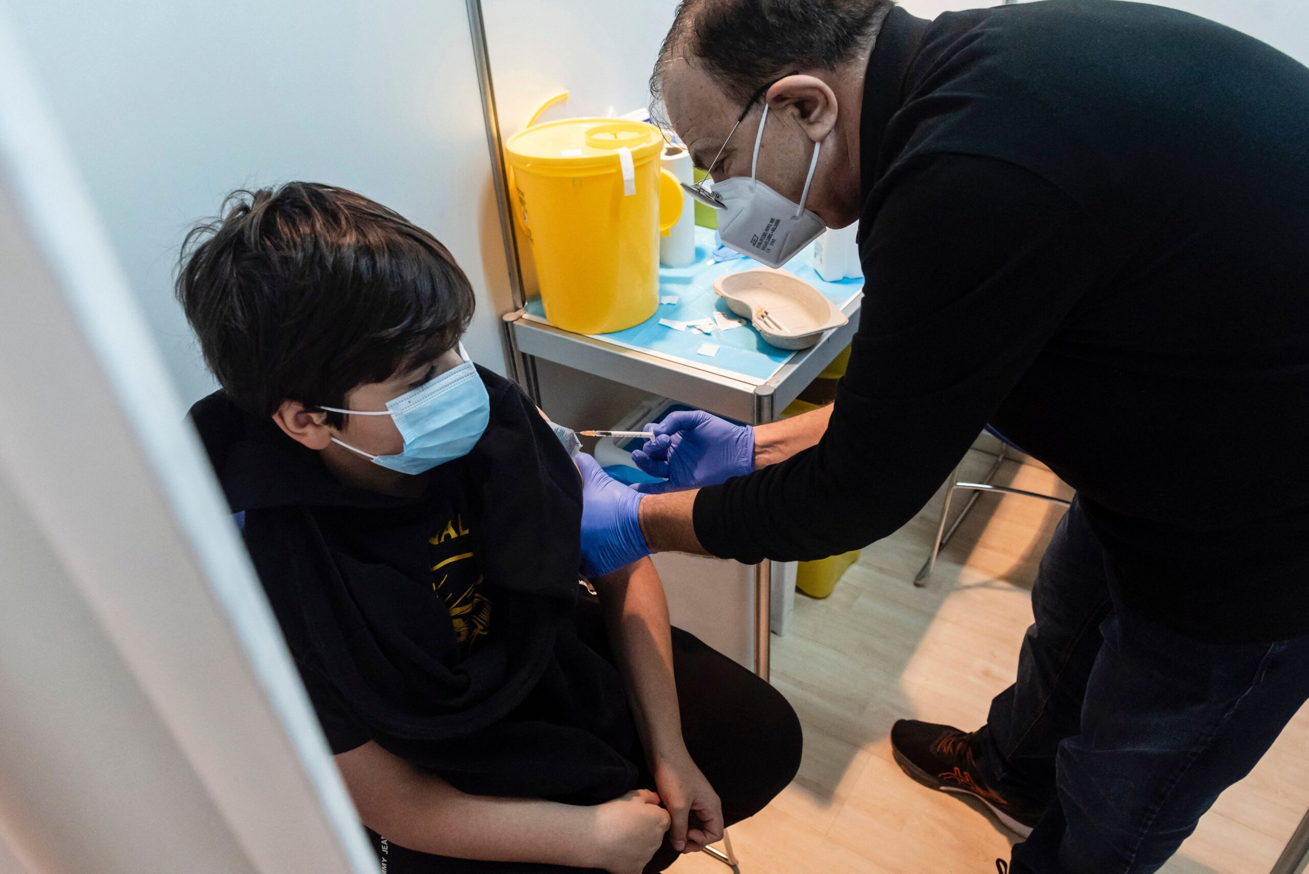 Medics administer the first dose of a Covid-19 vaccine in the Cypriot capital Nicosia, on January 2, 2022, as the country begins vaccinations for children between the ages of five and eleven, amid a sharp surge in coronavirus cases.