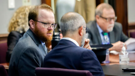 travis mcmichael in court talking to his attorney