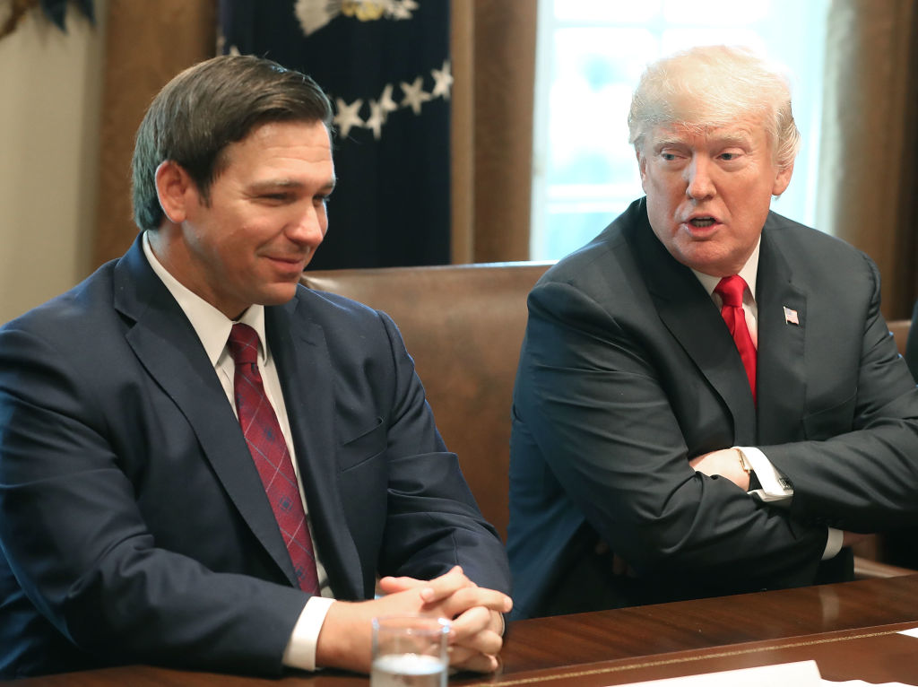 ron DeSantis at table with donald trump