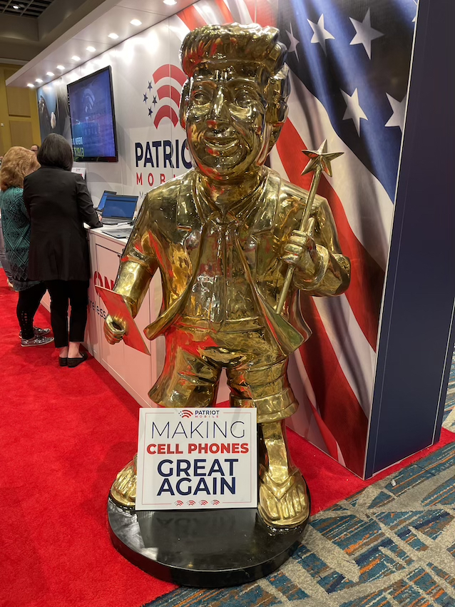 golden trump statue at patriot mobile booth at CPAC