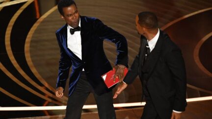 Chris Rock reacts to being slapped by Will Smith at the Oscars