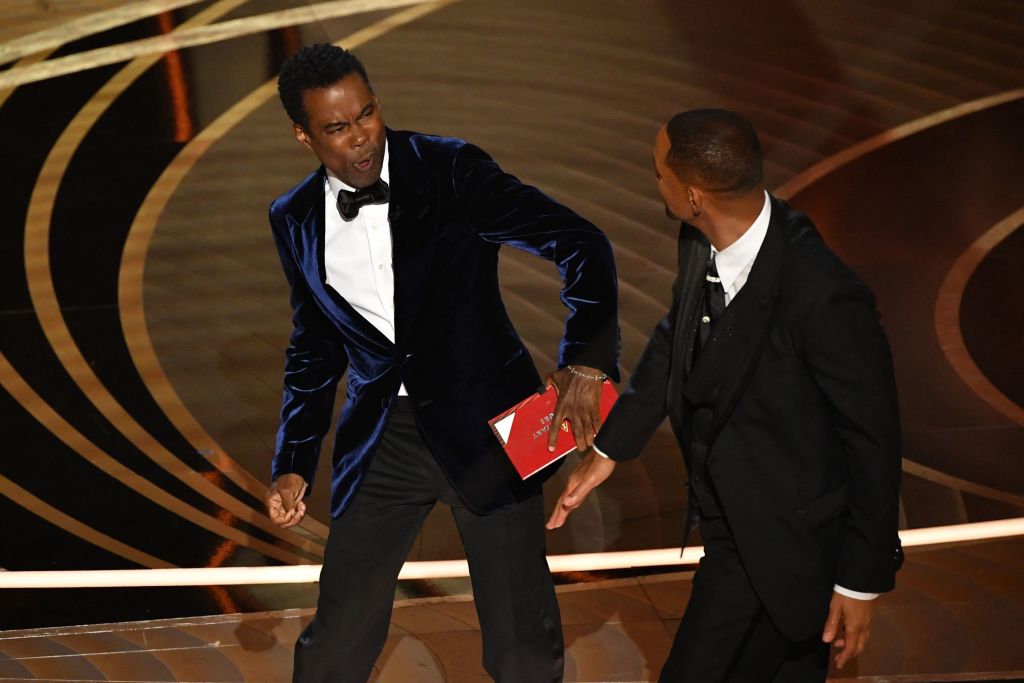 Chris Rock reacts to being slapped by Will Smith at the Oscars