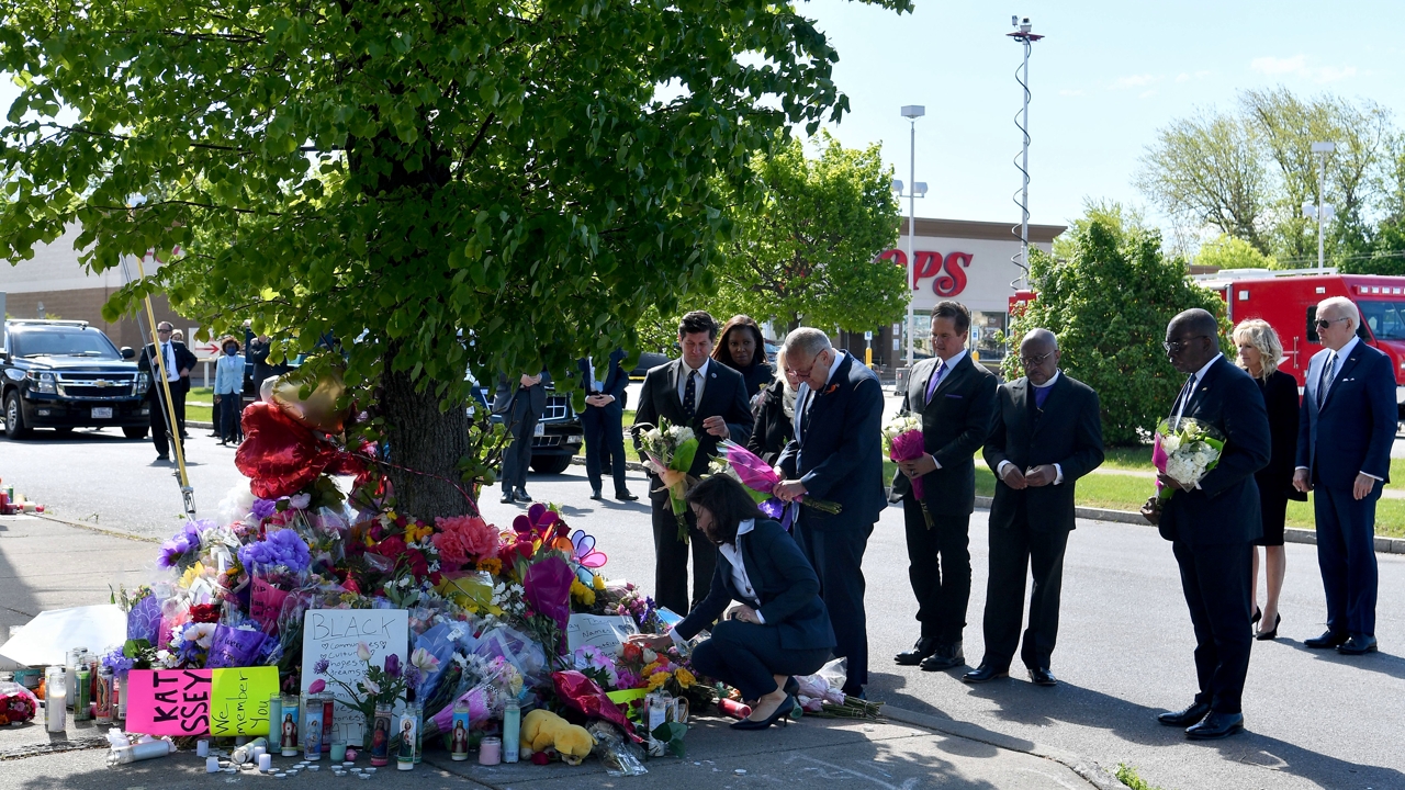 US President Joe Biden (R) and US First Lady Jill Biden (2R) look on as New York State Governor Kathy Hochul and US Senate Majority Leader Chuck Schumer (D-NY) read a note at a memorial near a Tops grocery store in Buffalo, New York, on May 17, 2022. - Biden is visiting Buffalo after ten people were killed in a mass shooting at a grocery store on May 14, 2022. (Photo by Nicholas Kamm / AFP) (Photo by NICHOLAS KAMM/AFP via Getty Images)
