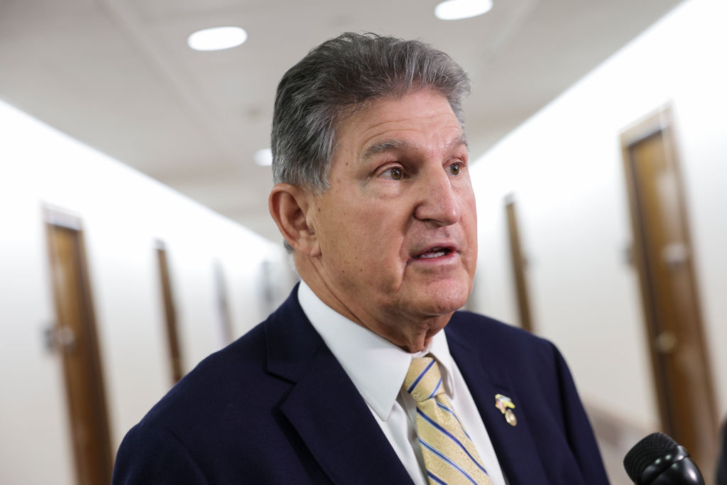 Joe Manchin speaking to reporters in senate office hallway