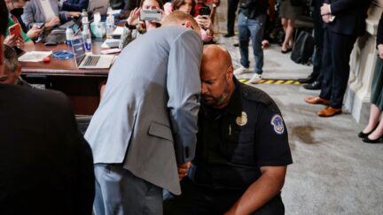 TOPSHOT - Stephen Ayres (L), who has pleaded guilty to entering the Capitol illegally on January 6, talks to US Capitol Police Officer Harry Dunn (R) at the conclusion of a full committee hearing on 