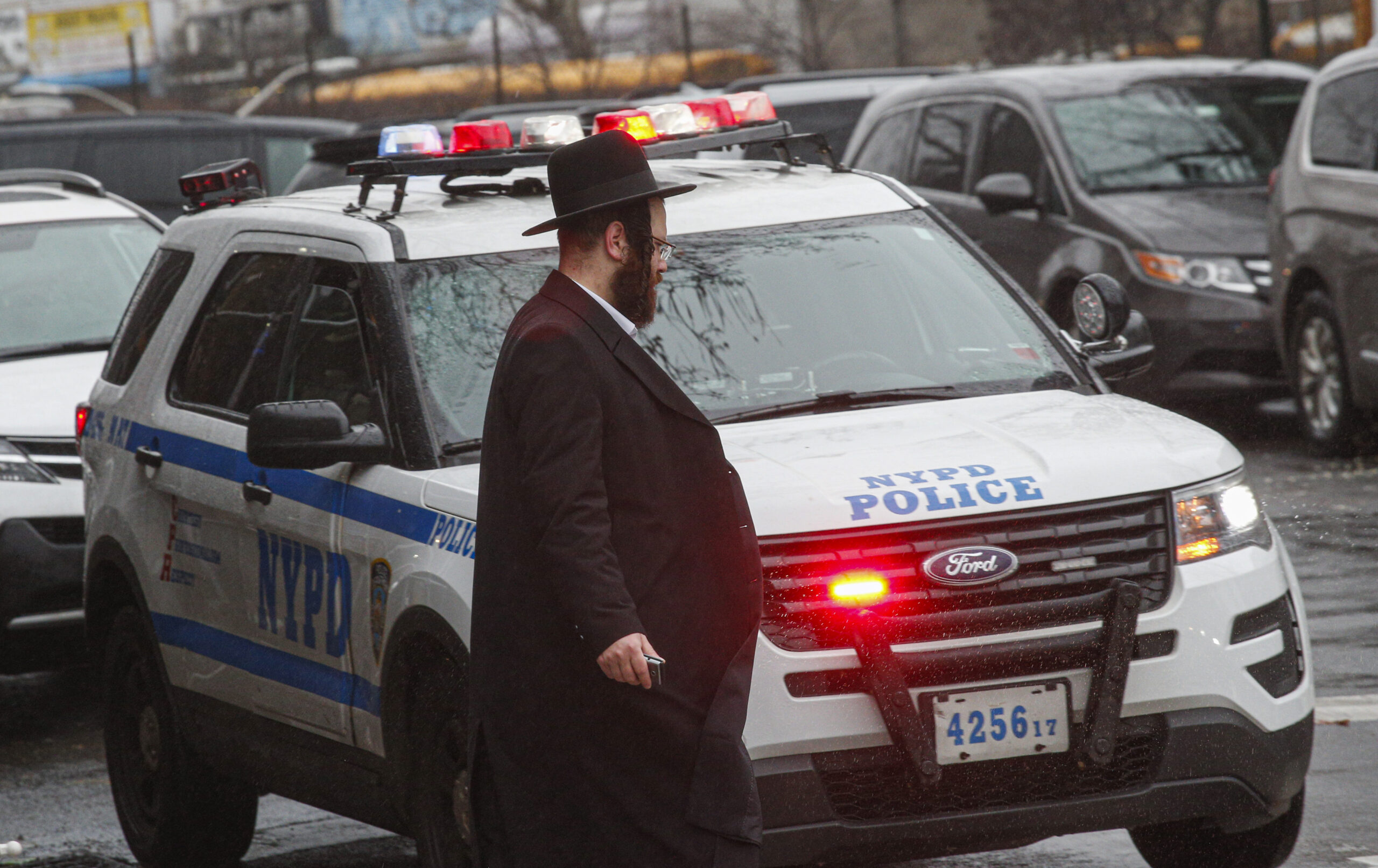 Jewish man near NYPD vehicle