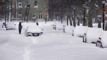 An abandoned car rests on a street in the Elmwood Village neighborhood of Buffalo, N.Y. Monday, Dec. 26, 2022, after a massive snow storm blanketed the city. Along with drifts and travel bans, many streets were impassible due to abandoned vehicles.