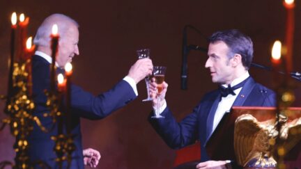 French President Emmanuel Macron and US President Joe Biden toast during a state dinner on the South Lawn of the White House in Washington, DC, on December 1, 2022.