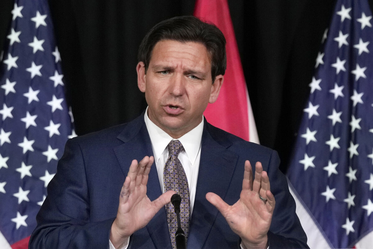 Florida governor Ron DeSantis with his hands up