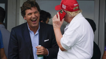 Tucker Carlson laughing with Donald Trump