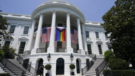 American flags and a pride flag hang from the White House during a Pride Month celebration on the South Lawn, Saturday, June 10, 2023, in Washington.