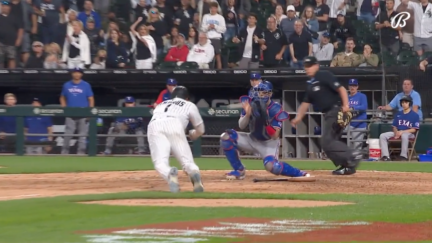 White Sox shortstop Elvis Andrus slides into home plate while Texas Rangers catch Jonah Heim attempts to tag him out