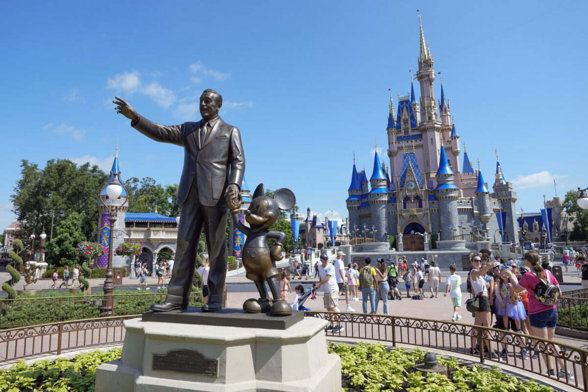 Statue of Walt Disney and Mickey Mouse in front of Cinderella Castle at Walt Disney World in Orlando, Florida.