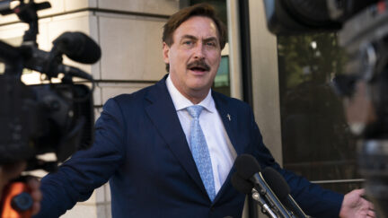 mike lindell talking to reporters outside a courthouse