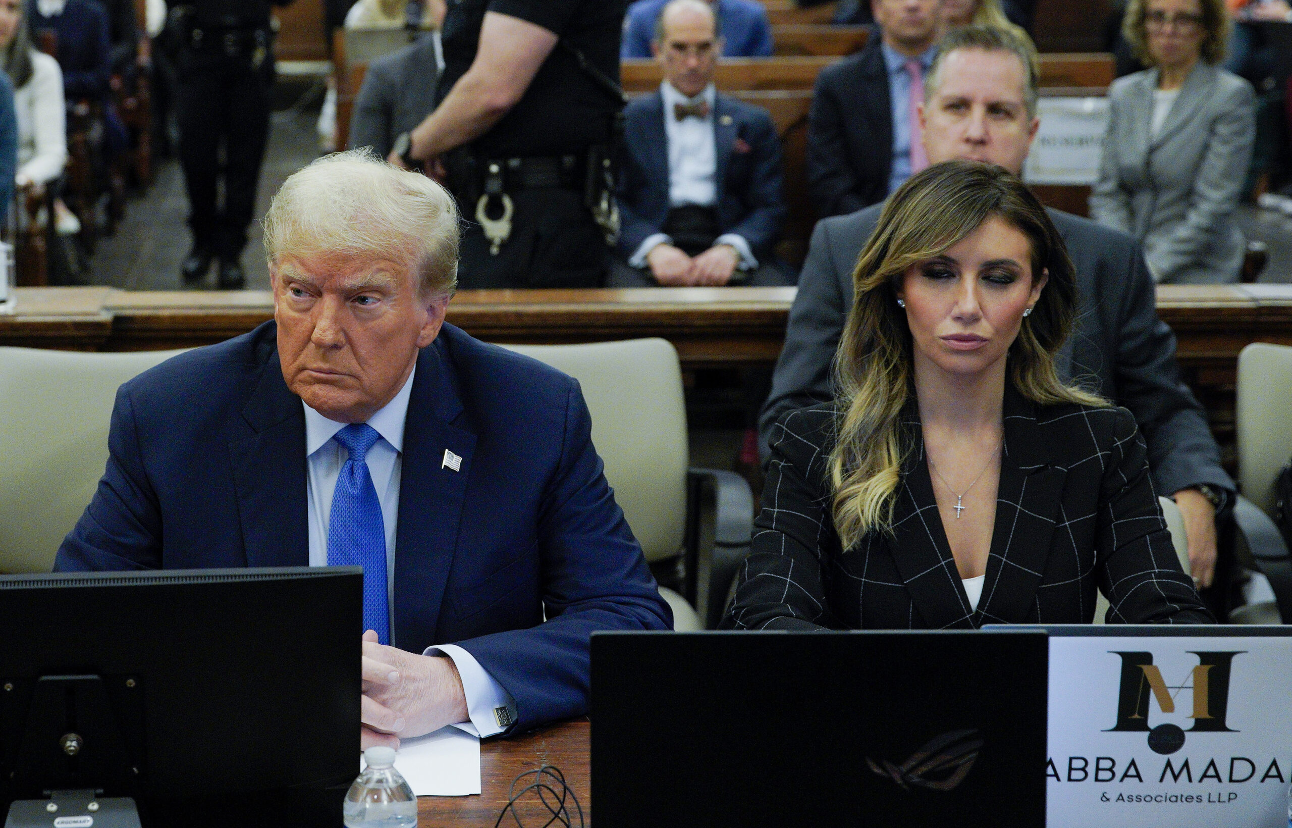 Donald Trump sitting next to attorney Alina Habba in courtroom