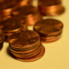 piles of pennies on a yellow background
