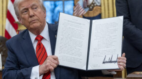 Donald Trump with executive order in Oval Office