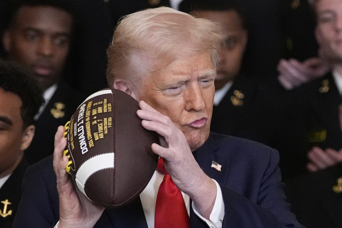 Donald Trump holding a football
