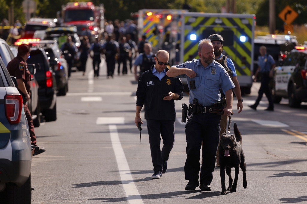 Law enforcement officers gather outside the Annunciation Church
