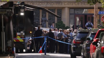 Law enforcement officers gather outside the Annunciation Church in response to a reported mass shooting, Wednesday, Aug. 27, 2025, in Minneapolis.