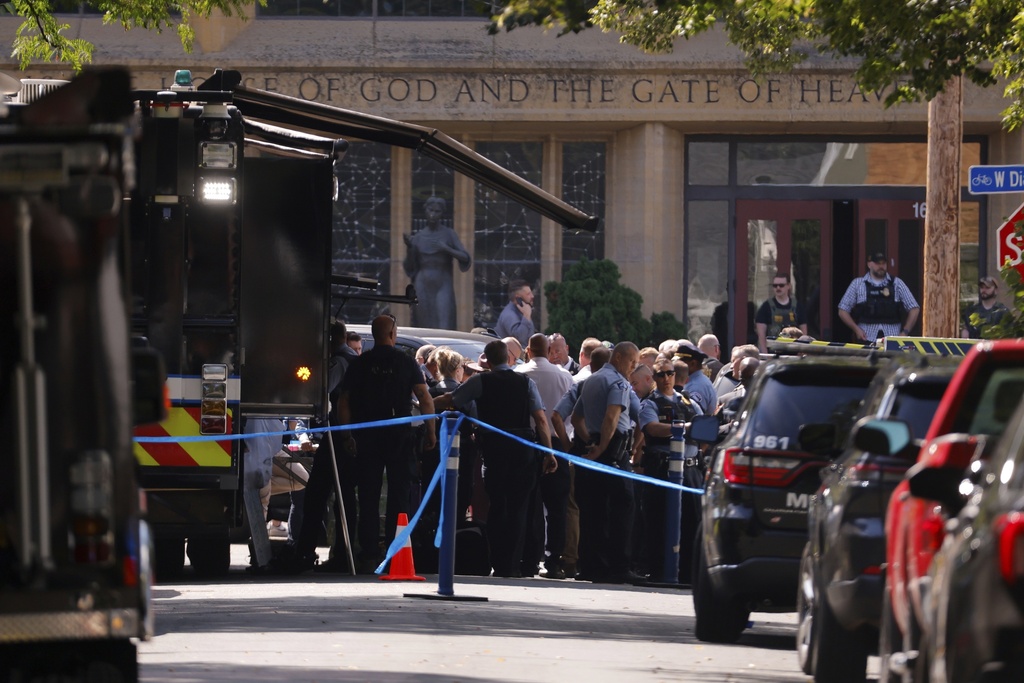 Law enforcement officers gather outside the Annunciation Church in response to a reported mass shooting, Wednesday, Aug. 27, 2025, in Minneapolis. 