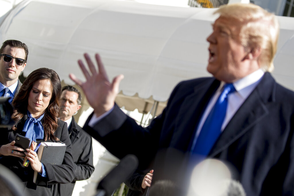 White House press secretary Stephanie Grisham listens as President Donald Trump, speaks to reporters on the South Lawn of the White House in Washington, Friday, Nov. 8, 2019, before boarding Marine One for a short trip to Andrews Air Force Base, Md. and then on to Georgia to meet with supporters. 
