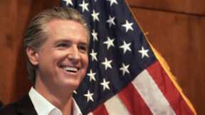 California Gov. Gavin Newsom in front of U.S. Flag