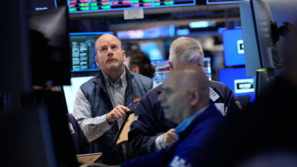 Traders work on the floor at the New York Stock Exchange in New York, Tuesday, April 7, 2026.