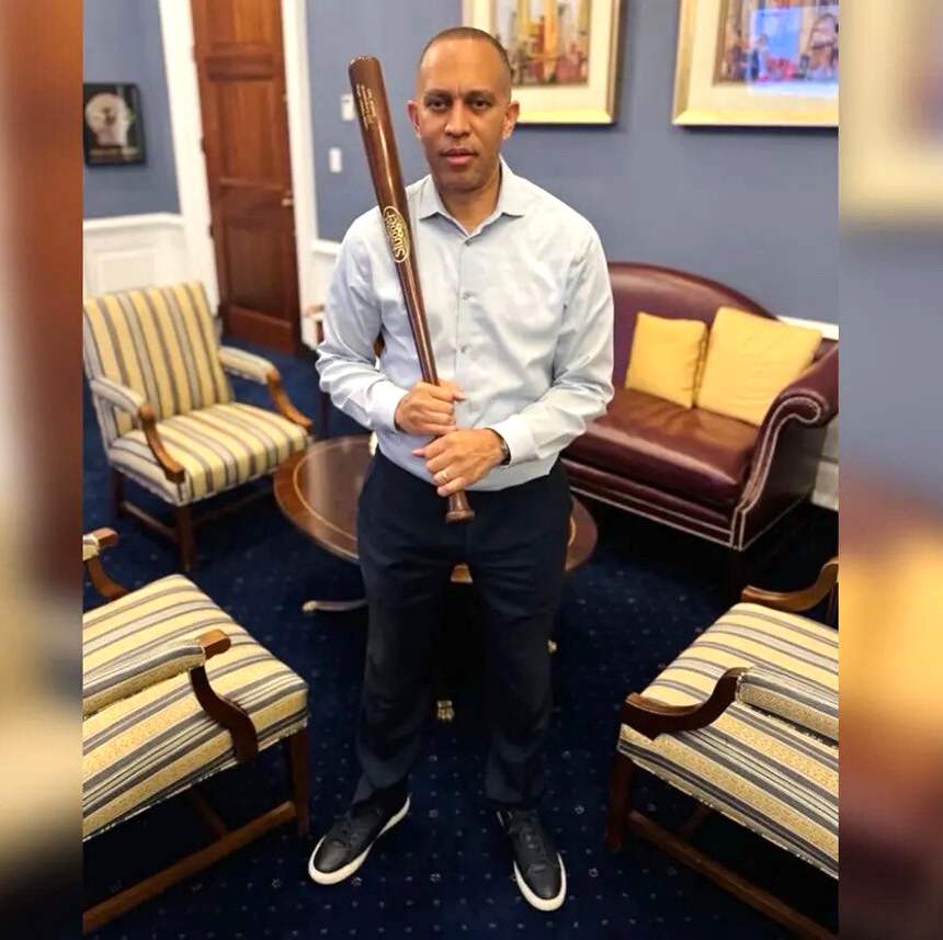 Hakeem Jeffries holding a baseball bat