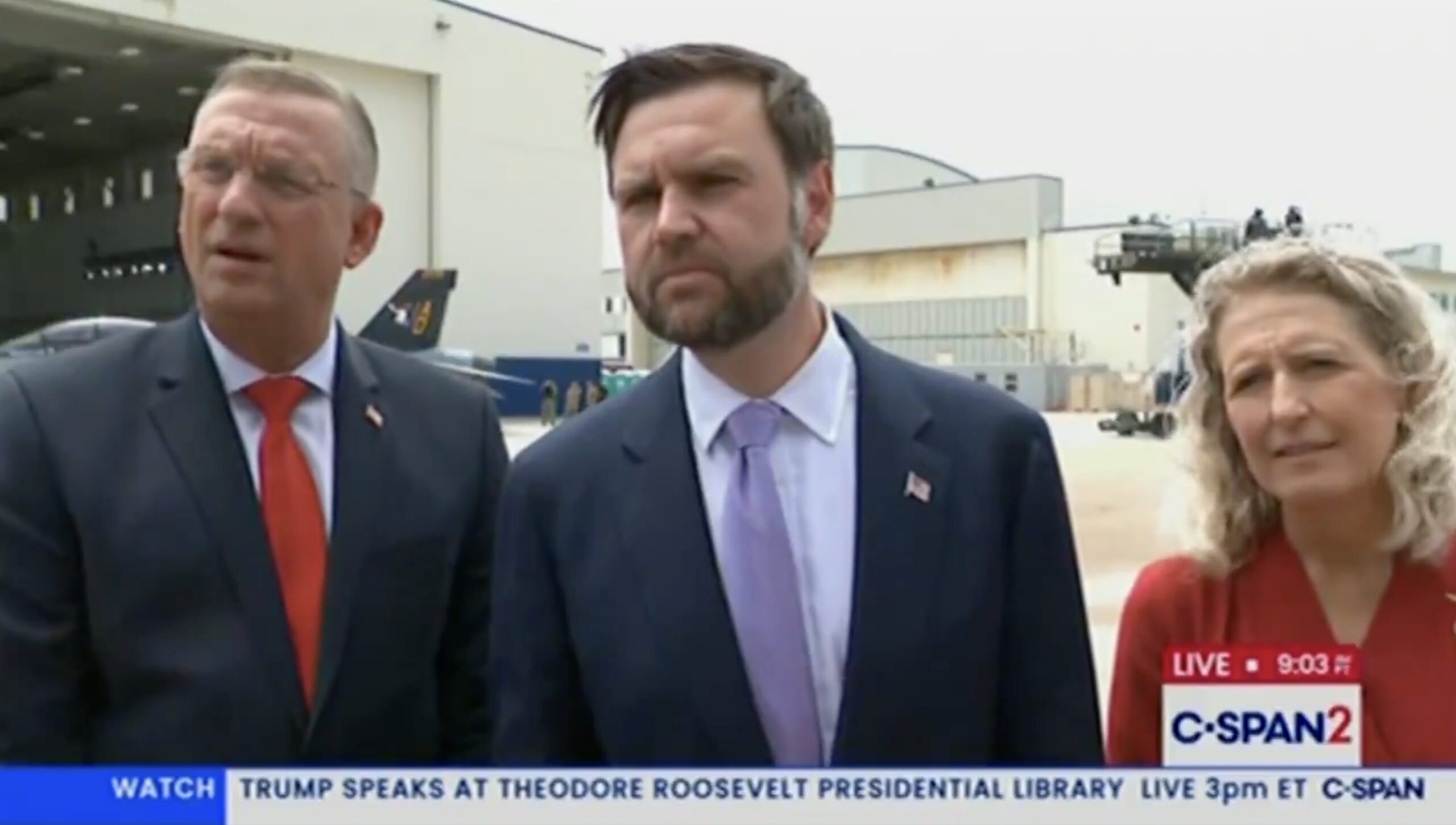 Vance on the tarmac answering questions from the press after speaking to American troops