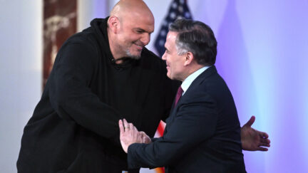 Sen. John Fetterman, D-Pa., left, and Sen. Dave McCormick, R-Pa., right, greet before participating in a debate moderated by Fox News anchor Shannon Bream, not shown, Monday, June 2, 2025, at the Edward M. Kennedy Institute for the United States Senate, Monday, June 2, 2025, in Boston, as livestreamed on Fox Nation. (AP Photo/Steven Senne)