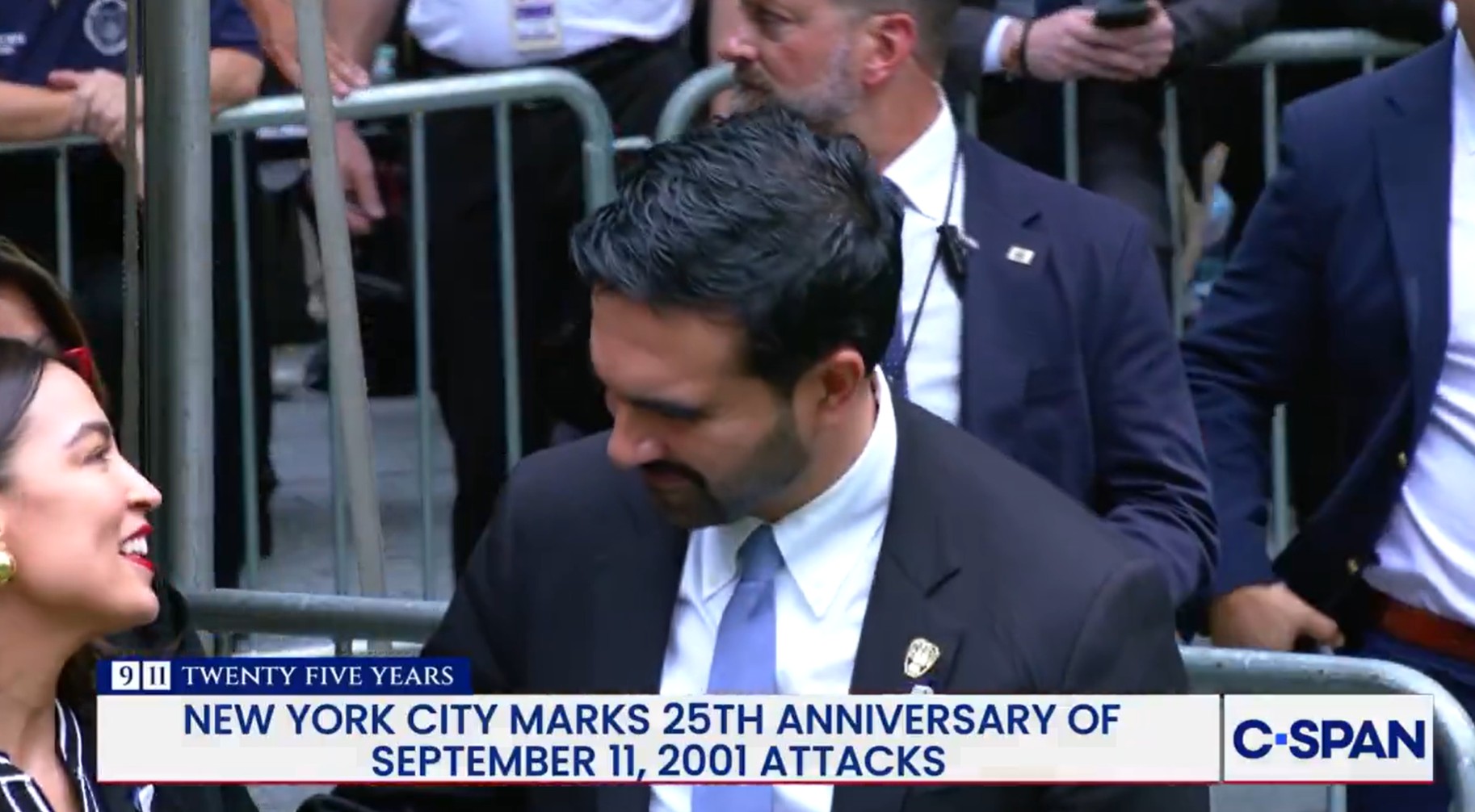 C-SPAN screenshot showing Alexandria Ocasio-Cortez speaking with Zohran Mamdani during the September 11 2026 anniversary ceremony
