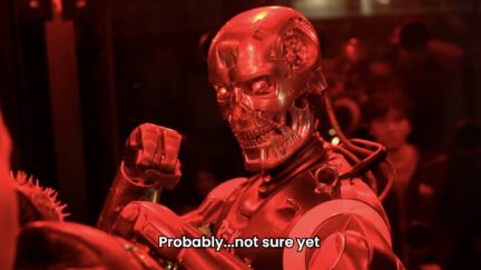 close up of humanoid robot from rek in a fighting pose with a red light on it