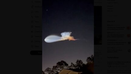 space jelly fish a light colored blob against dark night sky